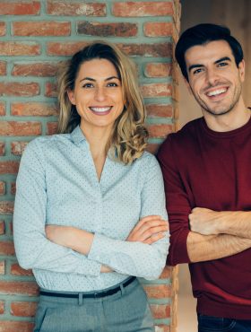 Portrait of happy business couple in office